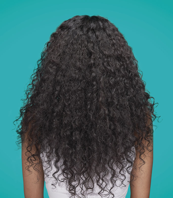 A picture of backside of hair before Smooth Stunner Blowout Creme