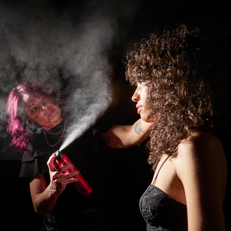 a picture of Anastacia Wagner styling a model's hair